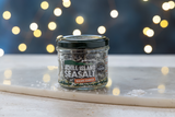 Jar of Achill Island Sea Salt with Atlantic Wakame on a surface with a blurred lights background