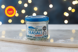 Jar of Achill Island Sea Salt on a surface with a blurred lights background
