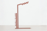 Decorative metal stand with 'Achill Island' text on a white background