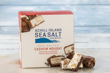 Box of Achill Island Sea Salt chocolate Cashew Nougat on a wooden surface with a blurred background