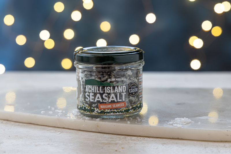 Jar of Achill Island Sea Salt with Atlantic Wakame on a surface with a blurred lights background