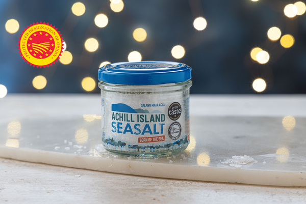 Jar of Achill Island Sea Salt on a surface with a blurred lights background