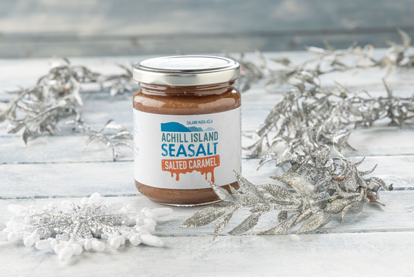 Jar of Achill Island Seasalt Salted Caramel on a wooden surface with decorative elements