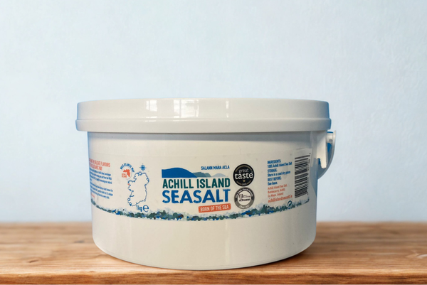 Bucket of Achill Island Seasalt on a wooden surface with a light blue background