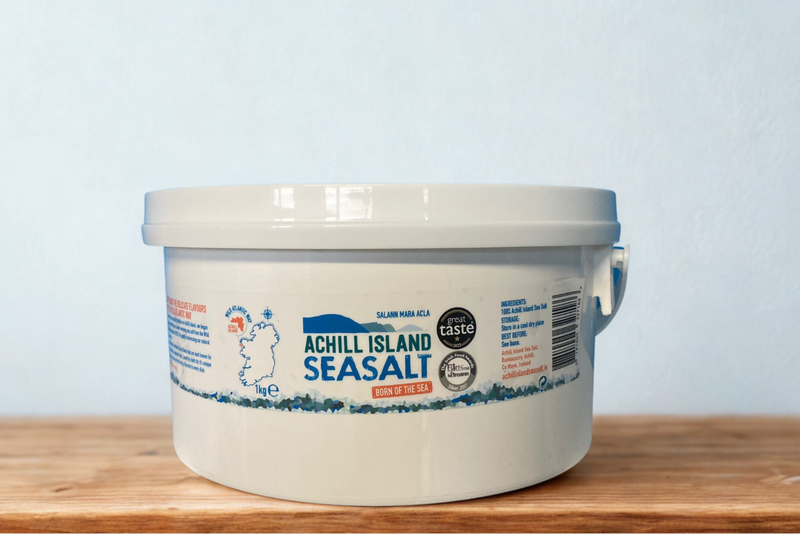 Bucket of Achill Island Seasalt on a wooden surface with a light blue background